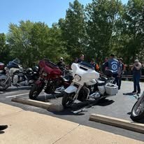 Motorcycles lined up at a charitable gathering