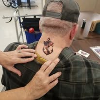 Community member showing a motorcycle-themed tattoo