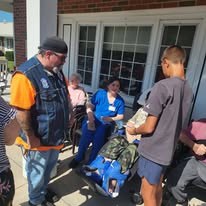 Riders and residents during a community visit