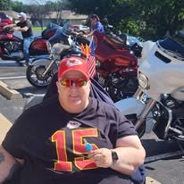 Supporter posing in front of motorcycles