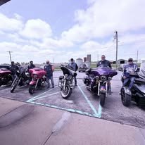 Motorcycles and riders assembled for a community event